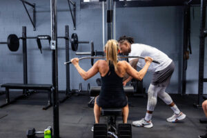 coach working one-on-one with a client during a personal training session in a modern fitness studio