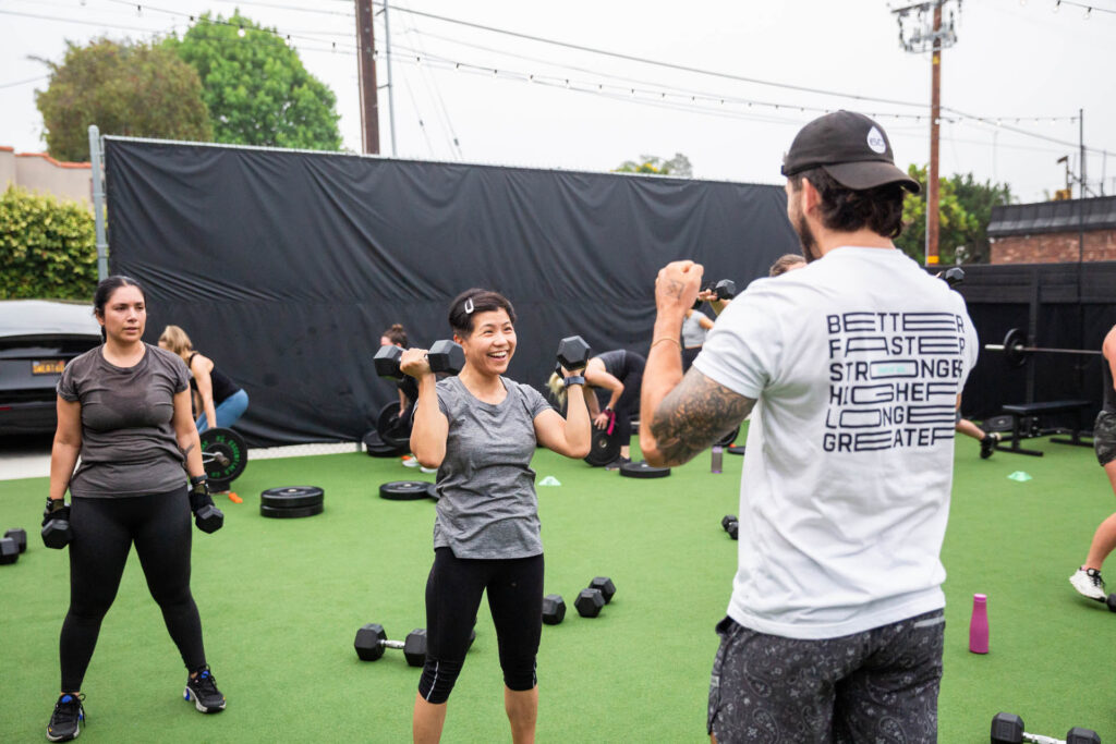 coach working one-on-one with a client during a personal training session in a modern fitness studio